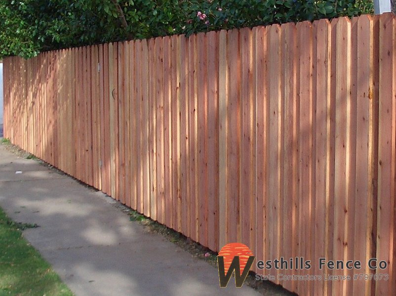 Dog-ear board on board redwood fence