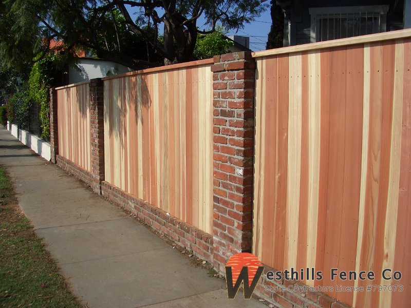 Tongue and groove redwood with brick posts