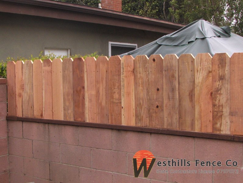 Dog-ear fence on the top of the wall