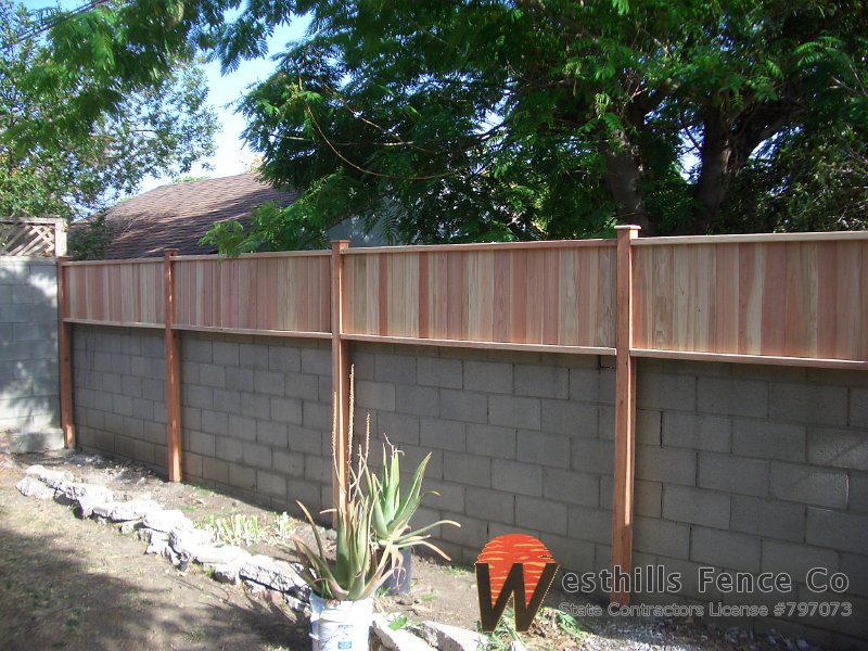 Tongue and gvoove redwood fence on top of wall